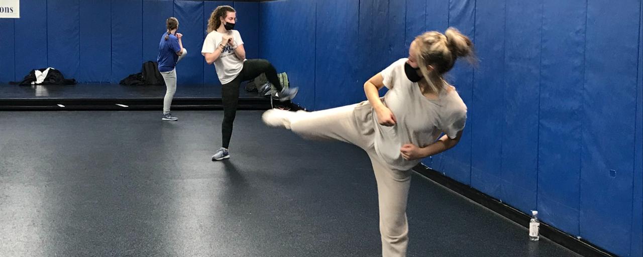 Student showing off their new skills learned in their kickboxing course